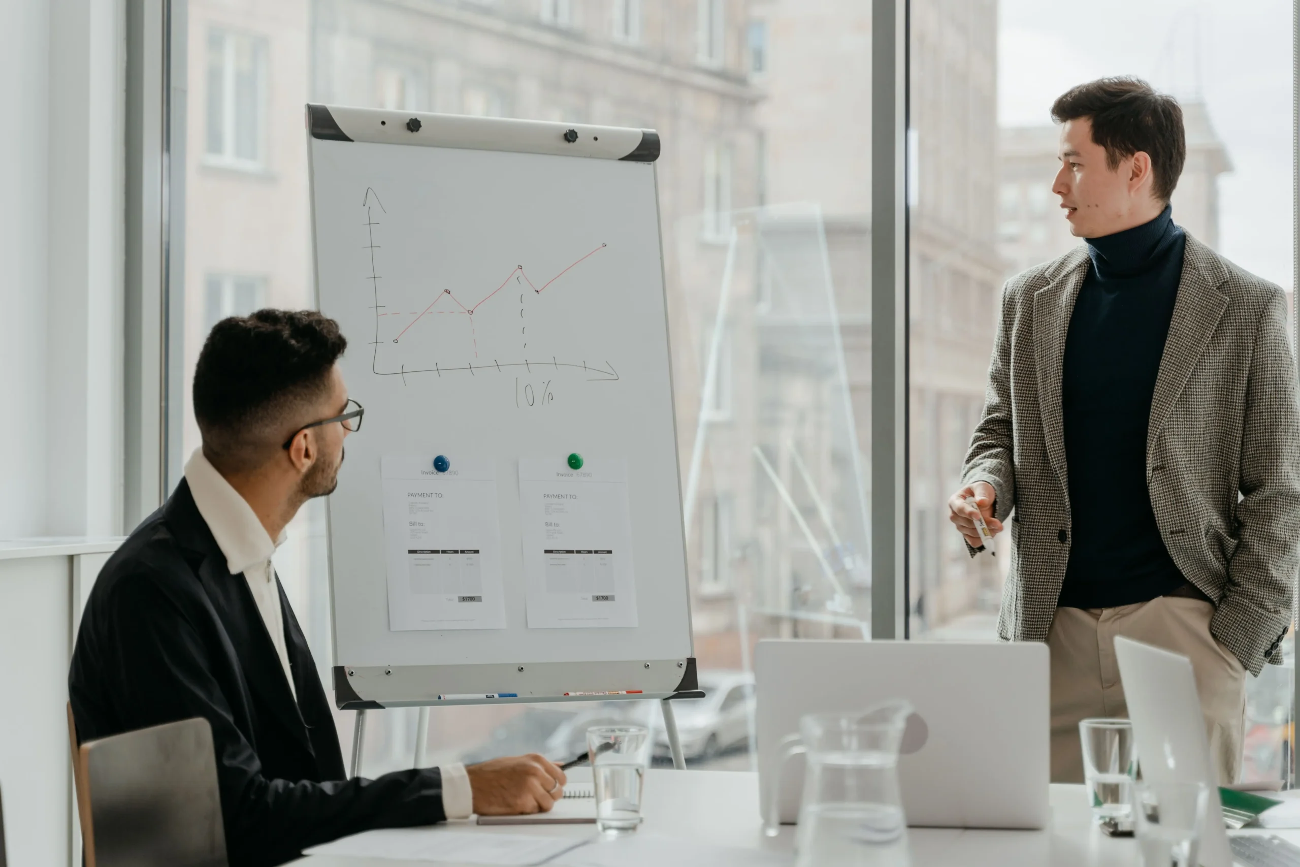 Two professionals analyzing marketing performance during a business meeting.