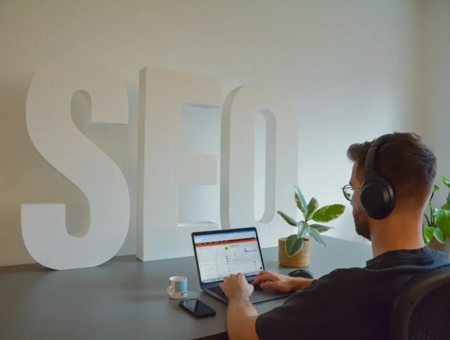 SEO specialist analyzing on-page SEO performance and website optimization metrics on a laptop dashboard.